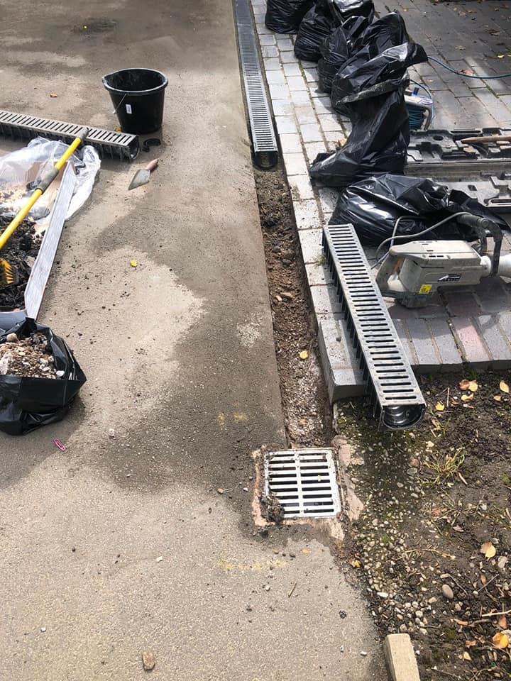 Channel drain being fitted along the edge of a driveway